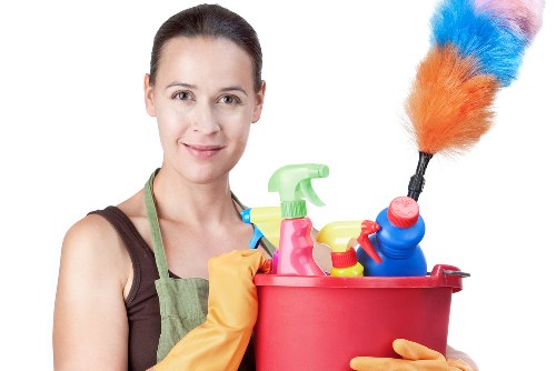 Carpet cleaning technician prepared with safety equipment in a home setting